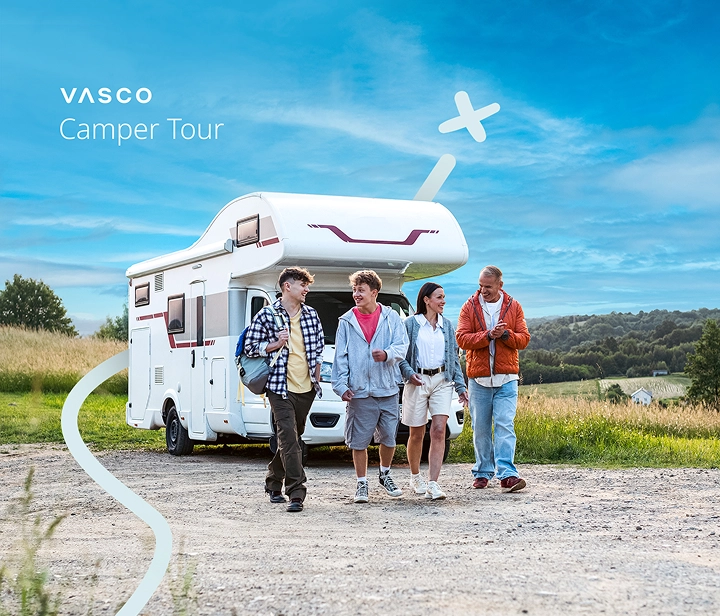A family of four — two parents and two children — walking away from their parked camper van on a sunny day. They are smiling, talking, and enjoying each other's company, creating a warm and relaxed atmosphere that reflects the joy of traveling together.